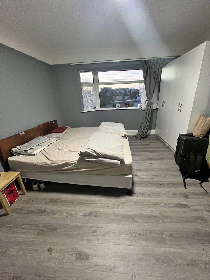 Bright and spacious twin room with wooden flooring and a large window with open views. Room includes: